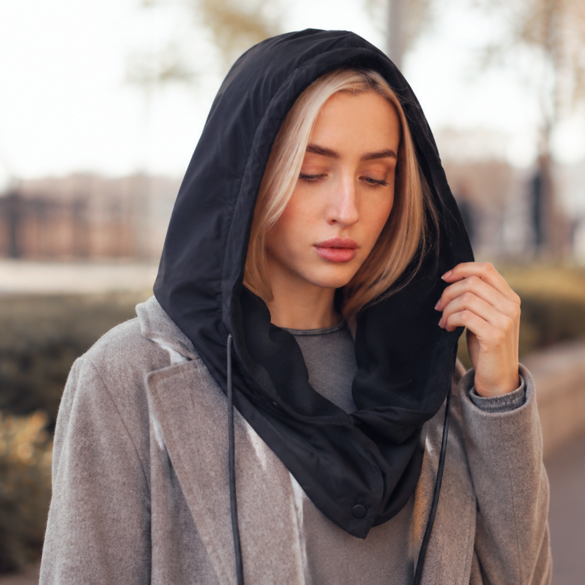Woman wearing a hooded scarf with head and neck coverage for everyday winter layering