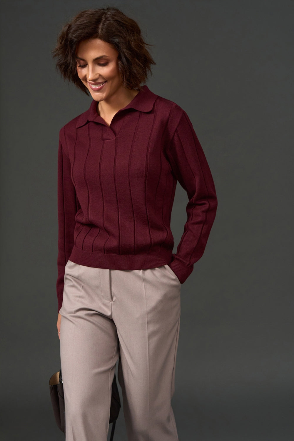Women's cashmere polo sweater styled on model with long sleeves and ribbed hem