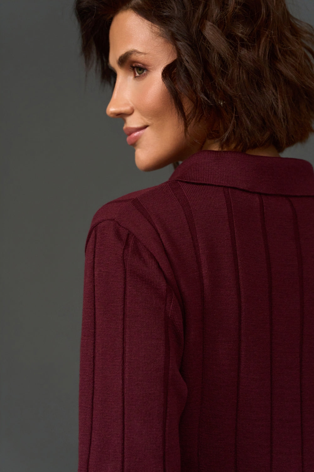 Close-up of women's cashmere polo sweater showing textured knit and polo collar