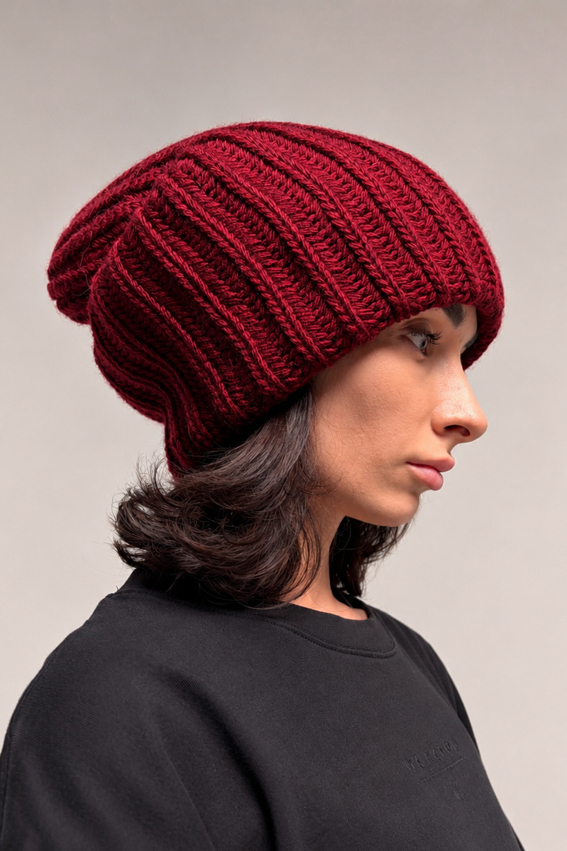 Burgundy chunky knit beanie styled with a relaxed slouchy silhouette