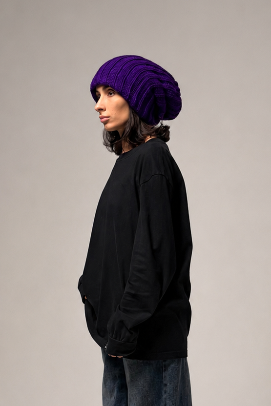 Violet slouchy beanie styled on model with an elongated relaxed shape