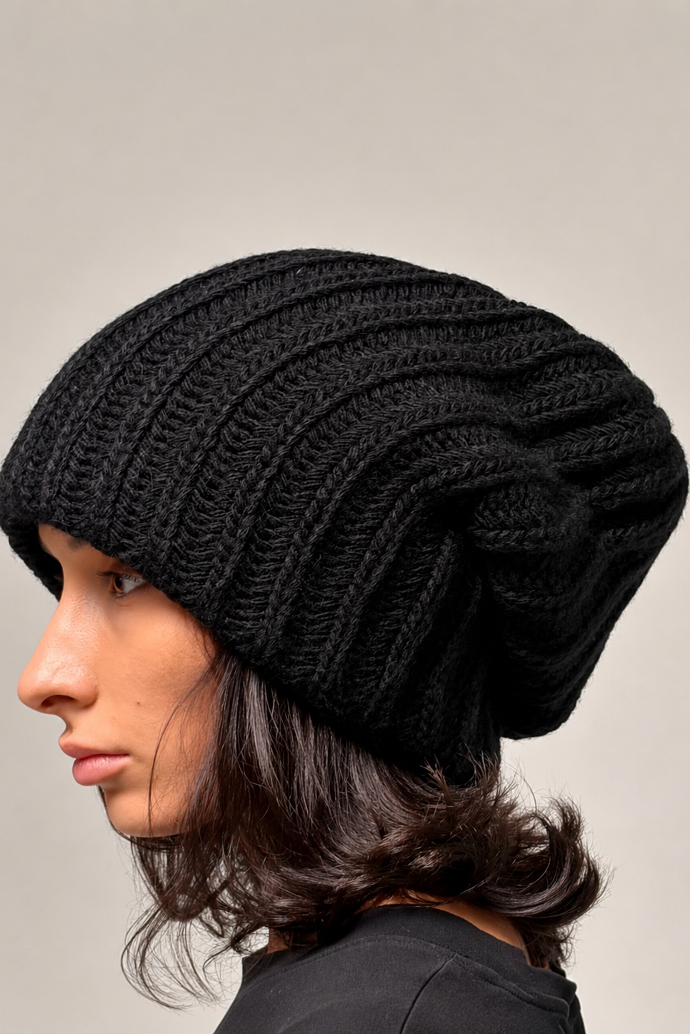 Black oversized chunky knit beanie worn in a relaxed slouchy style