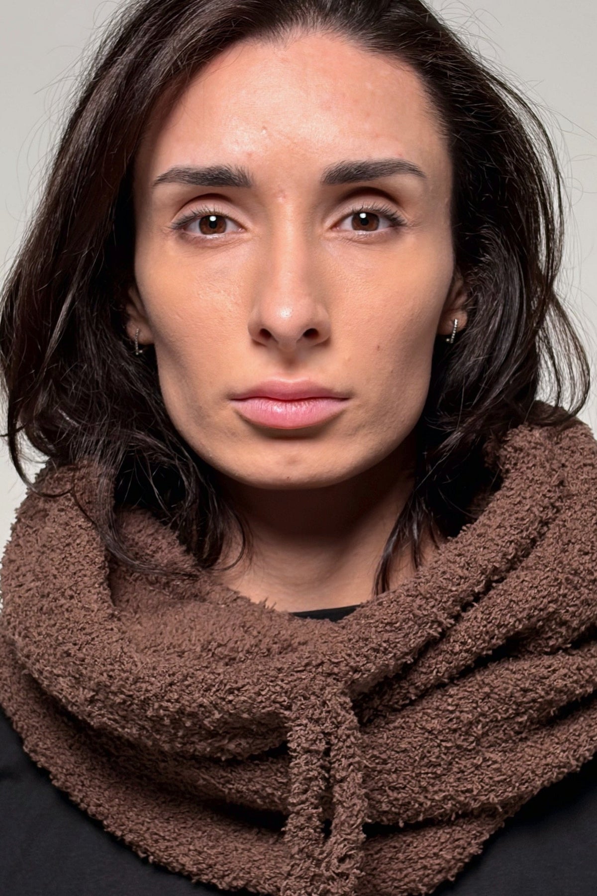 Brown convertible knit hooded scarf worn as a lightweight hood