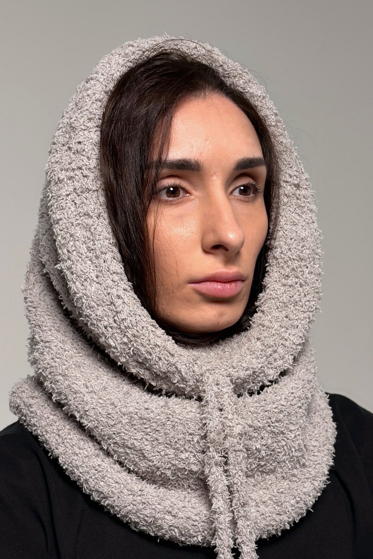 Gray knit cowl scarf styled as an easy pull-on neck warmer