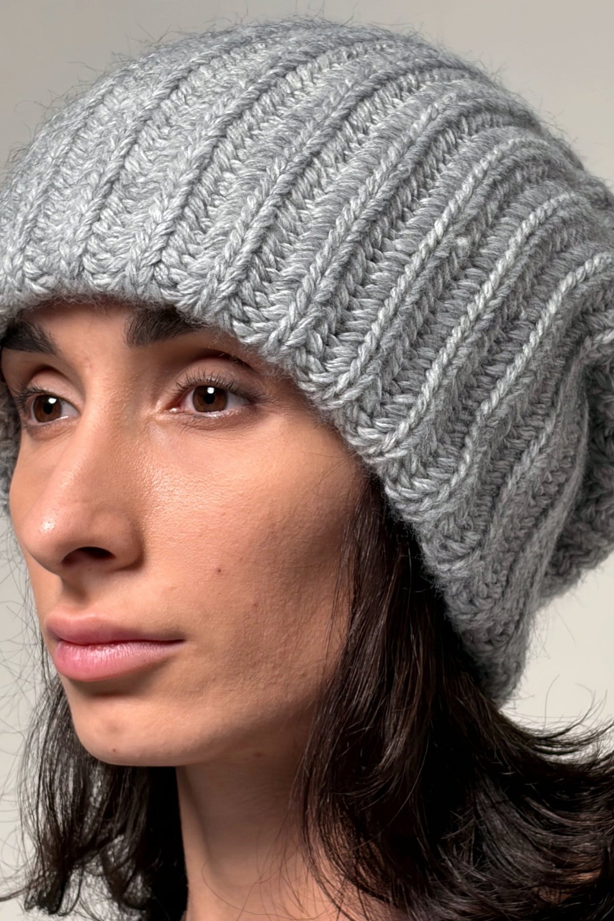 Gray oversized beanie showing textured knit and flexible slouchy shape