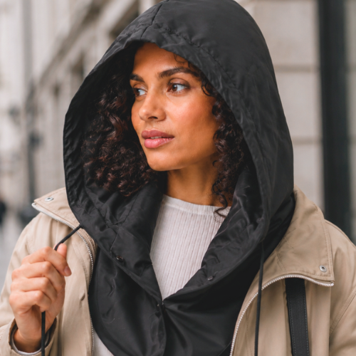 Woman wearing a hooded scarf for rainy-weather coverage over natural hair