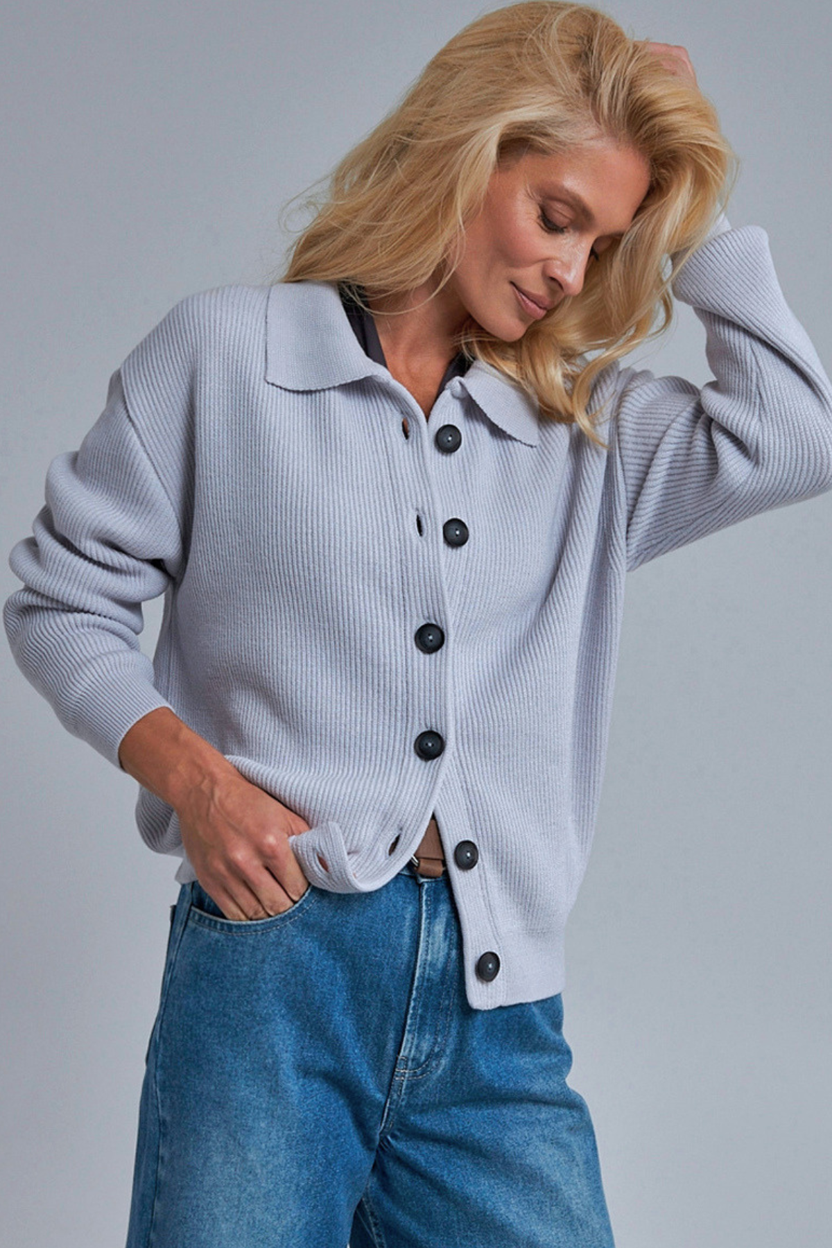 Woman wearing a sky blue women's knit cardigan.