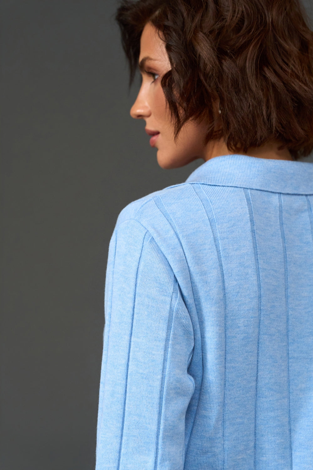Women's sky blue knit polo sweater styled on model with long sleeves