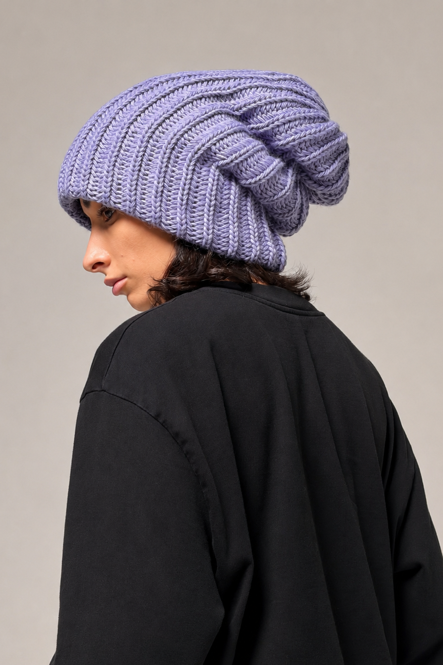 Lavender slouchy beanie showing textured knit and elongated shape