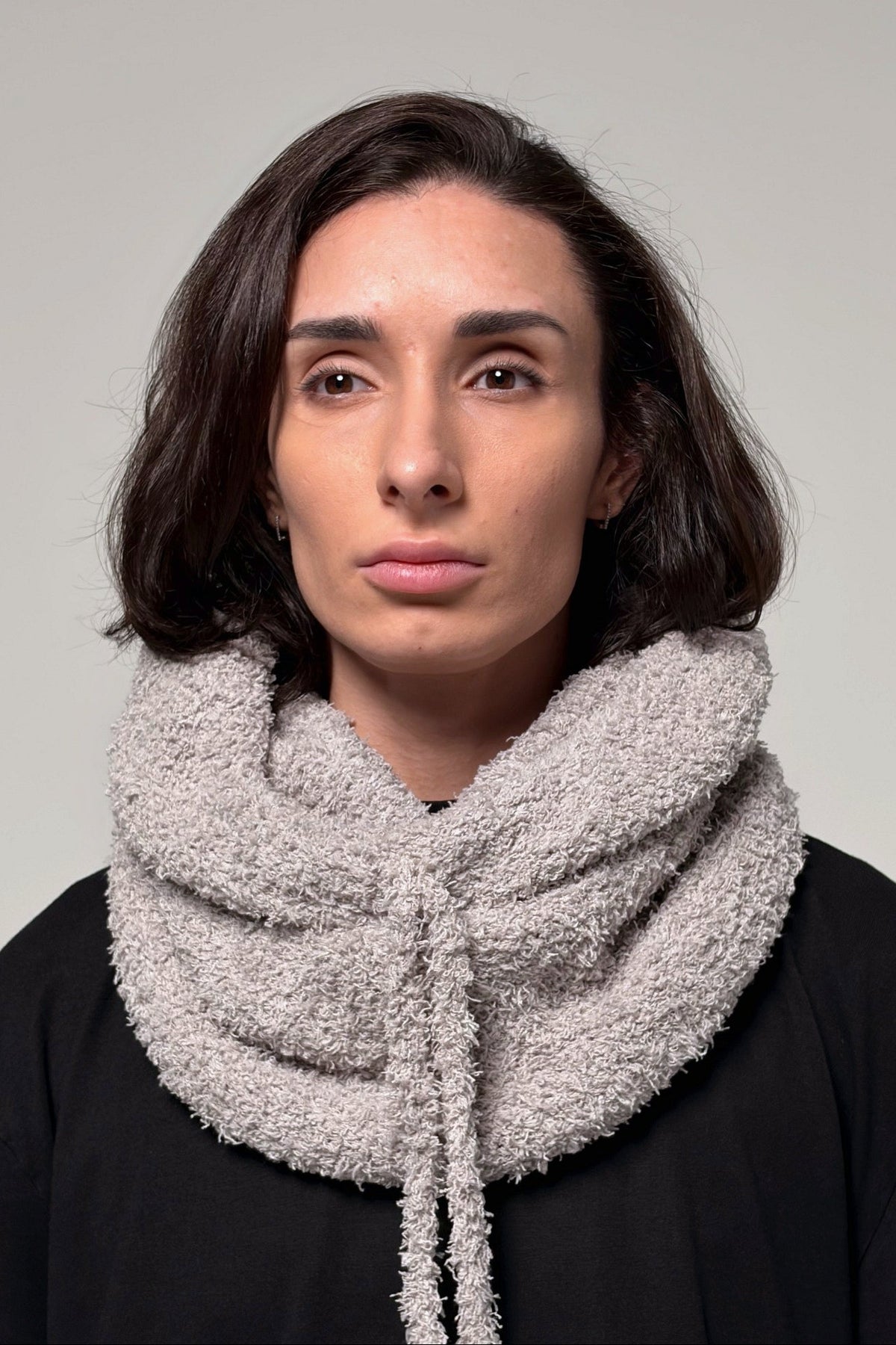 Gray convertible knit hooded scarf worn for head and neck coverage
