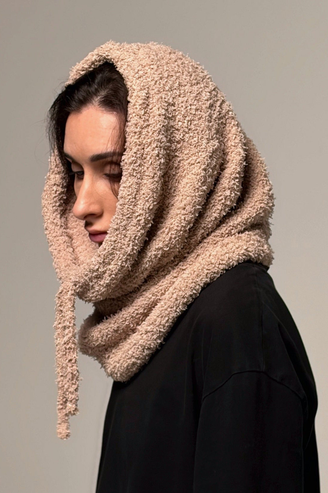 Beige convertible knit hooded cowl scarf worn as a lightweight hood